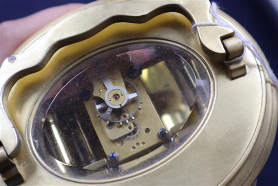 An Edwardian oval brass carriage clock, with travelling case height 13cm